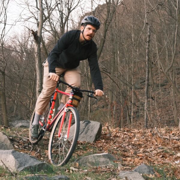 William riding bike around rocks